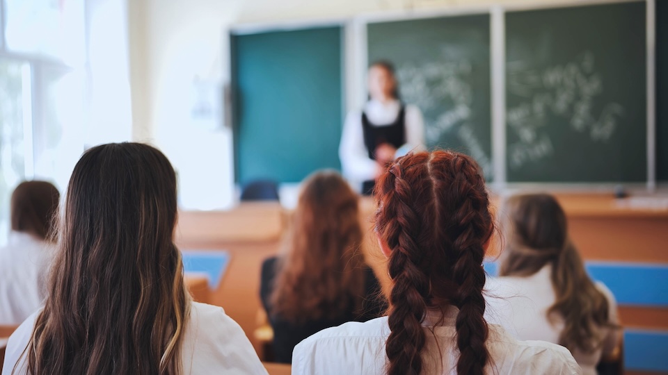 Students facing the front of the classroom 