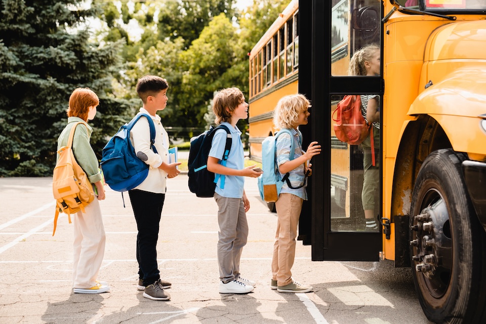 Kids getting on a school bus in Magnolia ISD